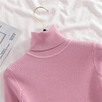 Pink ribbed knit turtleneck sweater close-up of high collar and knit texture