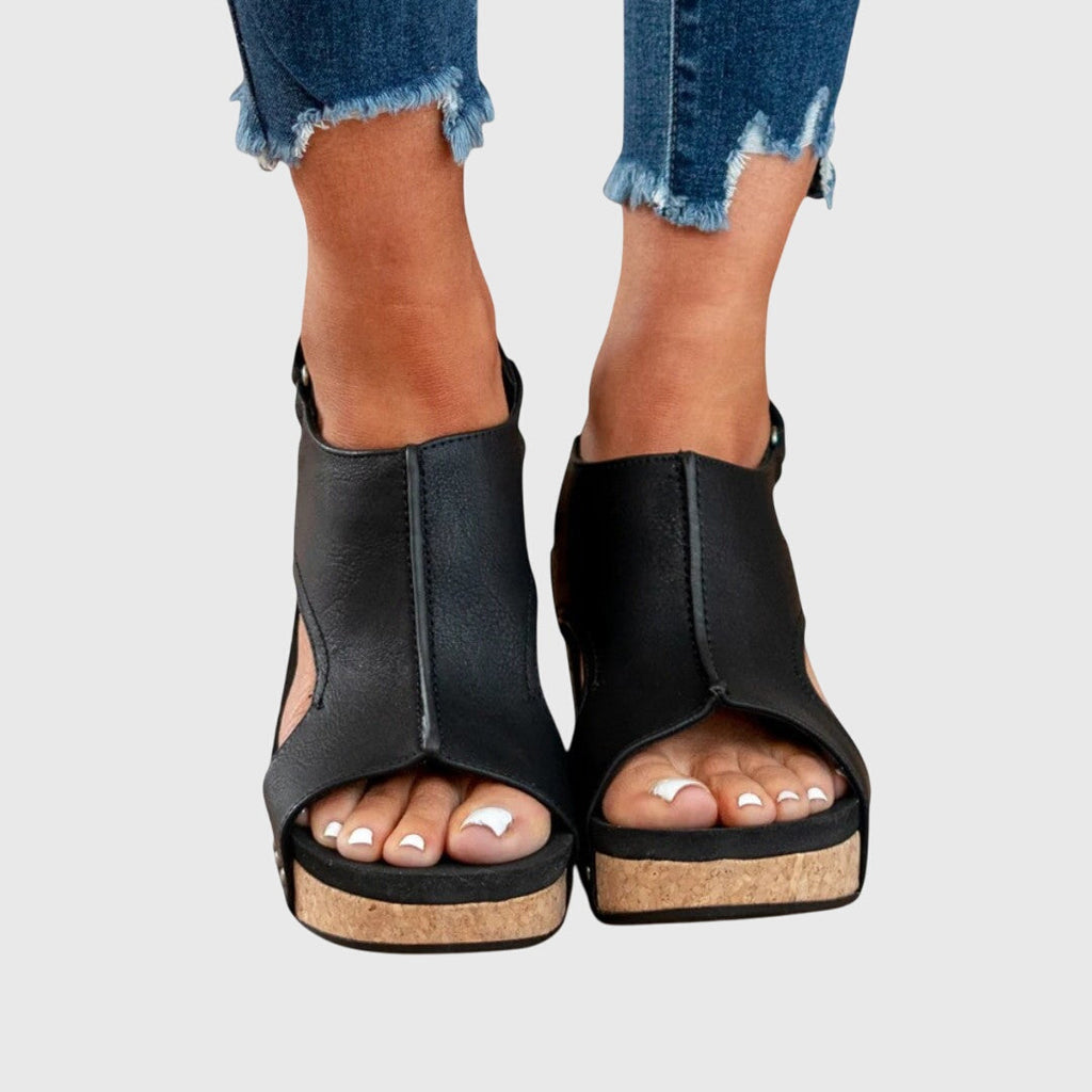 Black open-toe wedge sandals with cushioned sole and adjustable ankle buckle