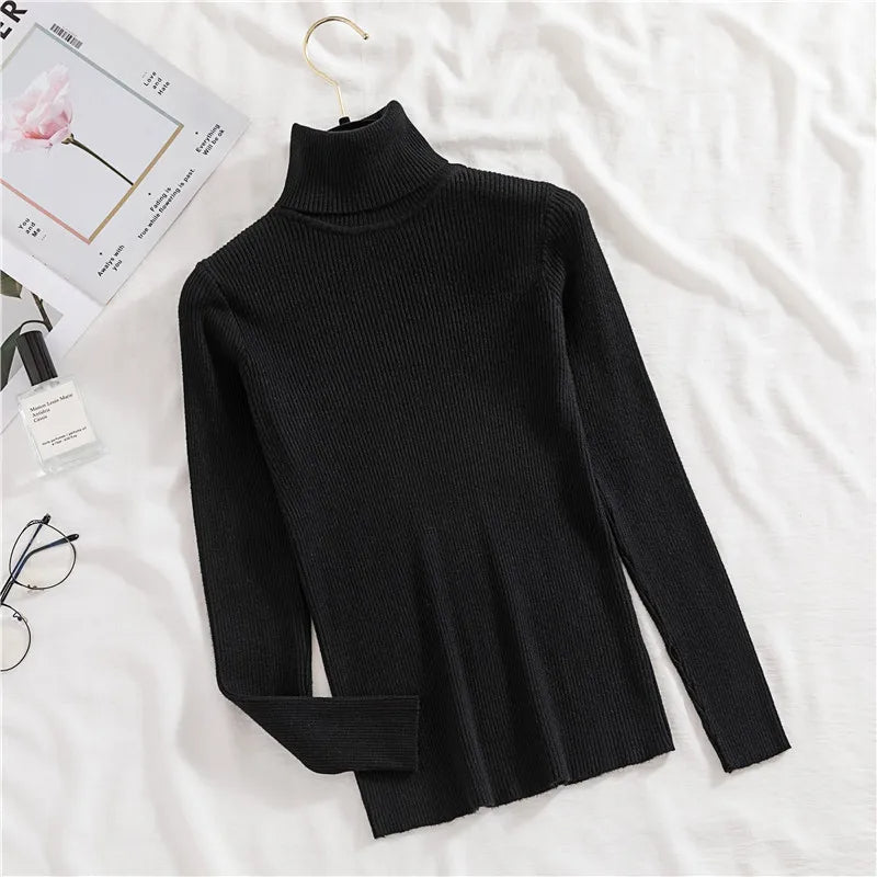 Black ribbed knit turtleneck sweater with long sleeves, hanging on a hanger