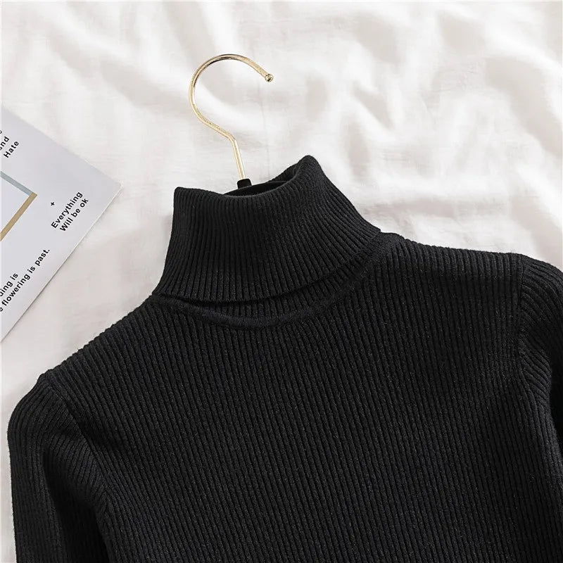 Black ribbed knit turtleneck sweater close-up of high collar and shoulder