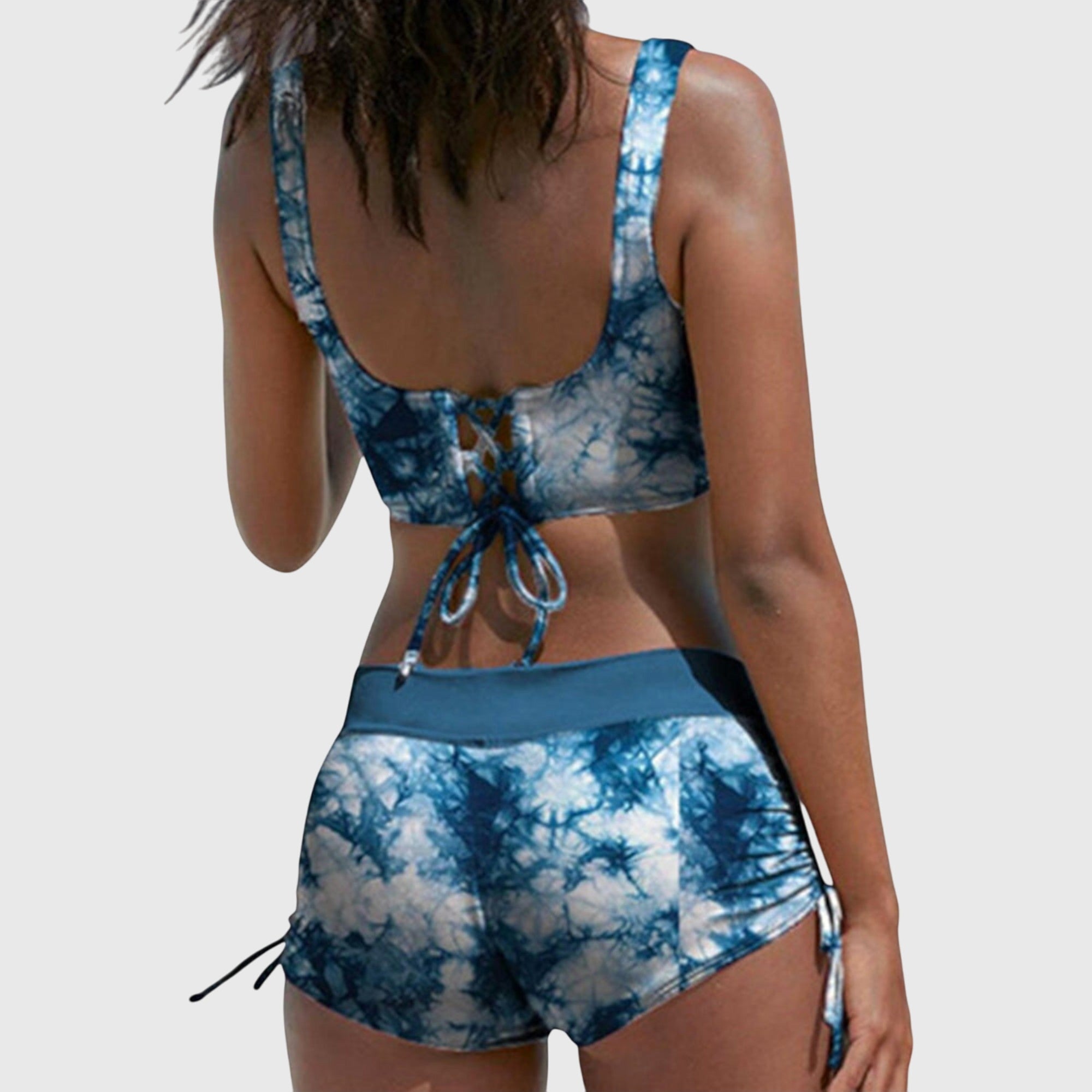 Blue tie-dye bikini set with lace-up cross-front bralette and drawstring swim shorts