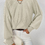 Women’s cable knit sweater with lantern sleeves, light brown, raised cable knit yoke.