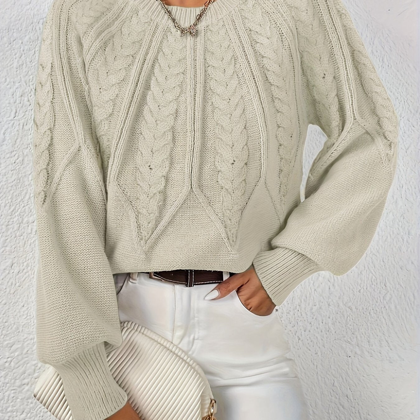 Women’s cable knit sweater with lantern sleeves, light brown, raised cable knit yoke.