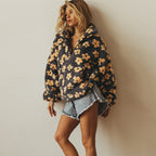 Women’s dark fuzzy quarter-zip sweater with yellow floral print and half-zip neckline