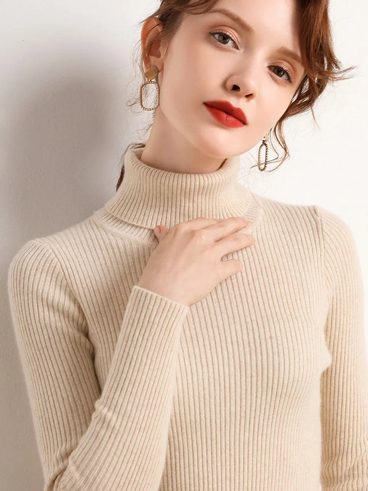 Soft knit turtleneck sweater in light beige with long sleeves and ribbed collar.