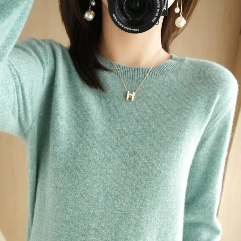 Teal crewneck pullover sweater with long sleeves and ribbed cuffs and hem