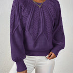 Women’s cable knit sweater with lantern sleeves, dark purple, textured cable yoke.