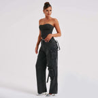 Black high-waist cargo jeans with relaxed fit and multiple leg utility pockets.