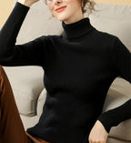 Black ribbed turtleneck sweater with high collar and long sleeves on a model.