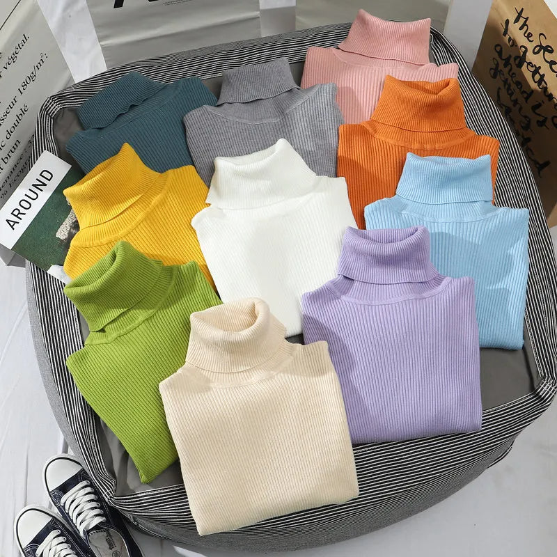 Folded turtleneck sweaters in mint, gray, peach, orange, blue, lavender, and white.