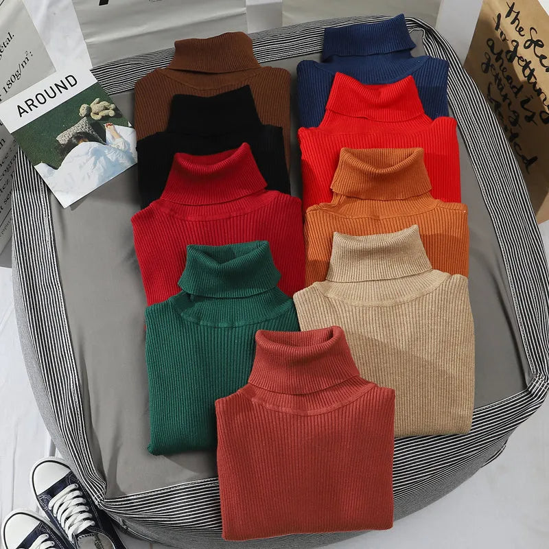 Folded turtleneck sweaters in brown, teal, red, green, tan, and rust orange tones.