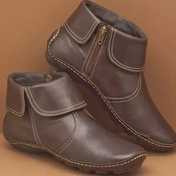 Women’s vintage-style ankle boots, dark brown with contrast white stitching and side zipper.