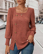 Rust orange ribbed knit blouse with square neckline, gold buttons, and curved side slit