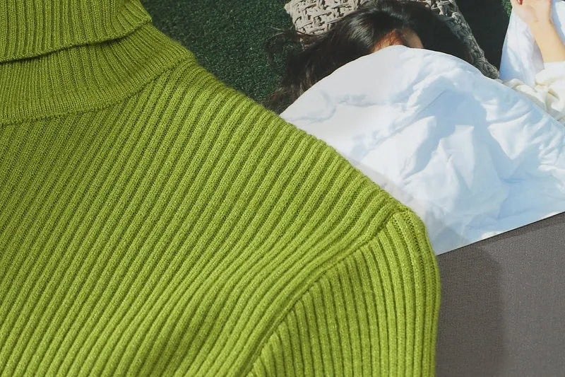 Lime green ribbed turtleneck sleeve and shoulder detail with high collar.