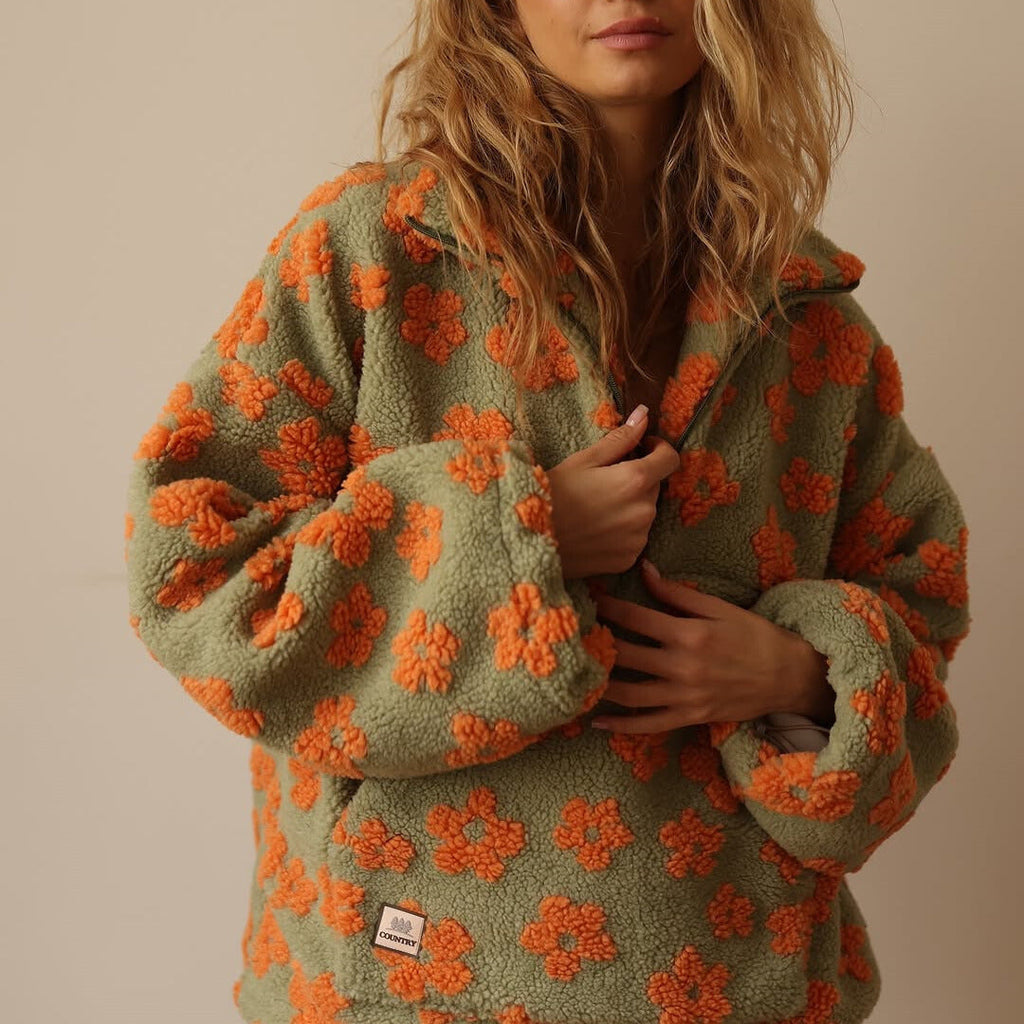 Women’s green fuzzy quarter-zip sweater with orange floral print and zip-front detail
