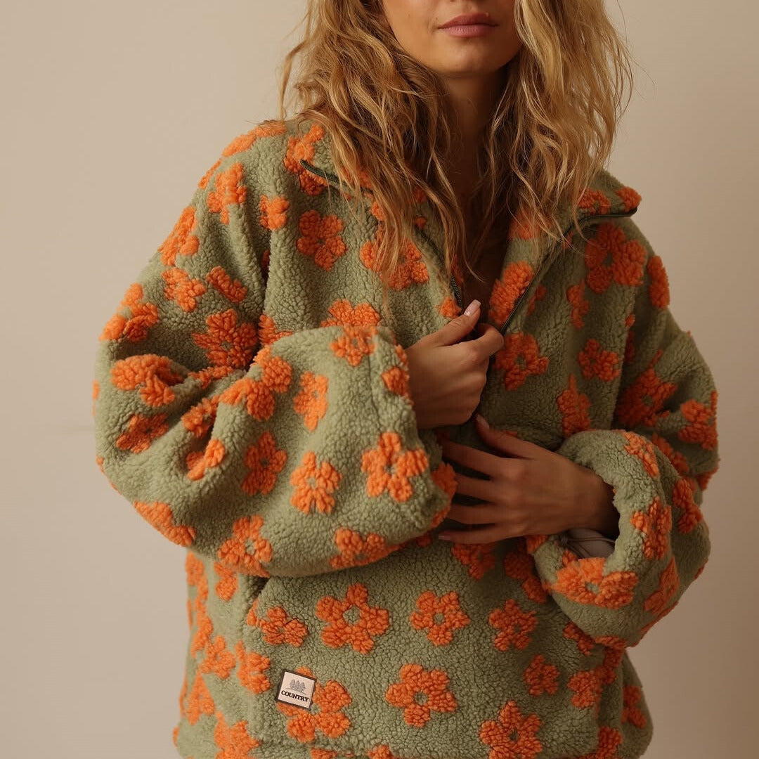 Women’s green fuzzy quarter-zip sweater with orange floral print and zip-front detail