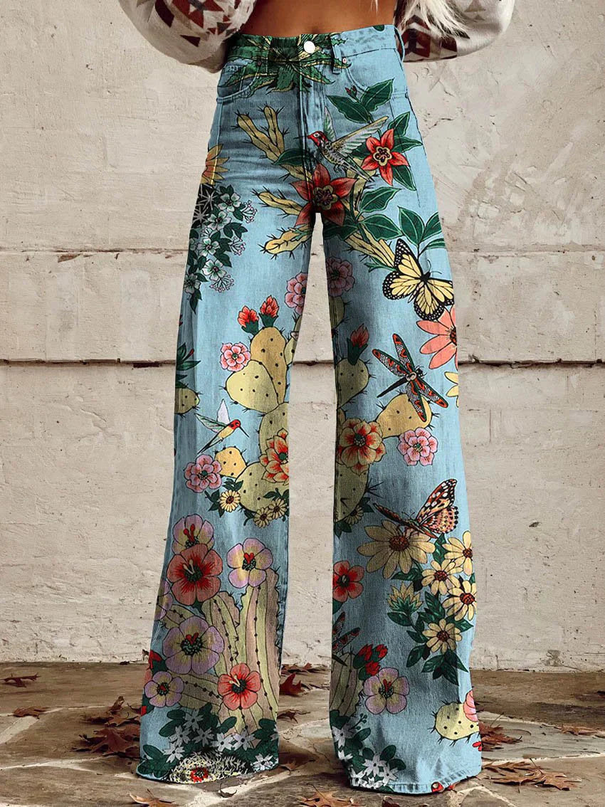 High-waist wide-leg pants with botanical floral print, blue fabric with multicolor blooms