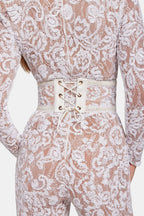 White lace jumpsuit with lace-up corset waist belt and long sleeves