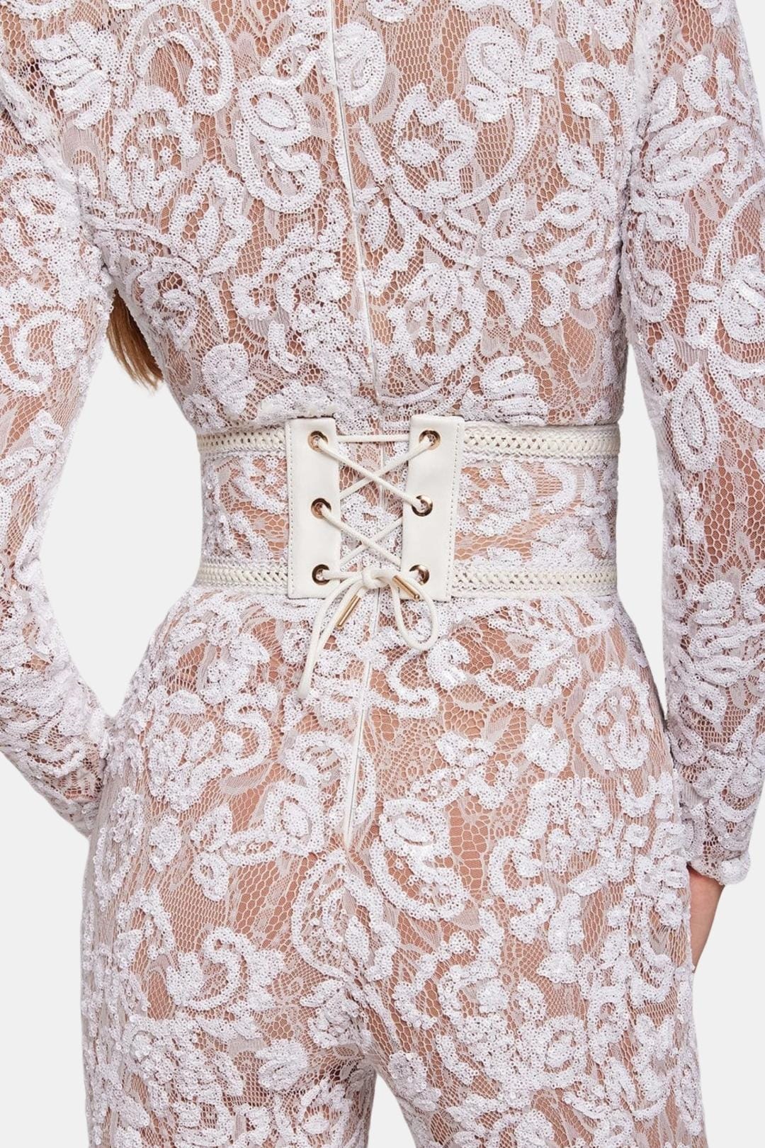 White lace jumpsuit with lace-up corset waist belt and long sleeves