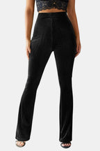 Black flared corduroy trousers with front pocket panels and wide bell flare