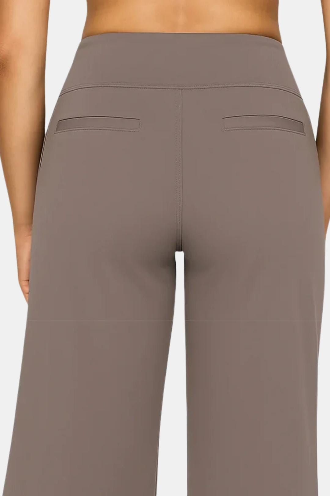 High-waist stretch pants in taupe, back view with welt pockets and straight legs