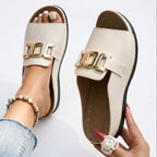 Cream open-toe sandals with gold-tone square buckle and stitched detailing