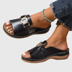 Black open-toe sandals with gold-tone square buckle and stitched sole