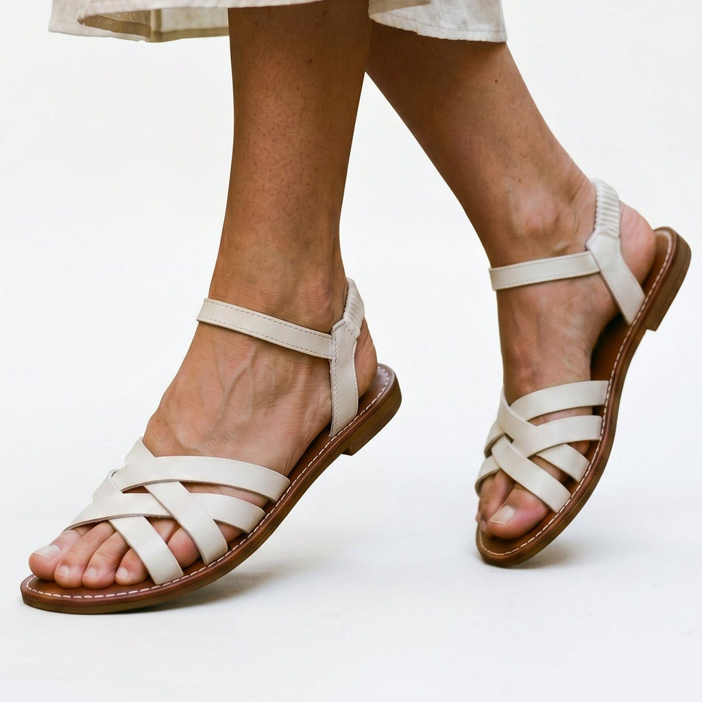 White strappy flat sandals with crisscross straps and open toe