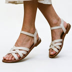 White strappy flat sandals with crisscross straps and open toe