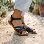 Dark thong flat sandals with wide cross straps and ankle buckle