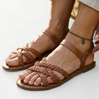 Tan braided flat strappy sandals with ankle strap and open toe
