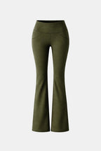 Green flared leggings with high waistband and wide bootcut legs
