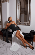 Strapless black maxi dress with thigh-high slit and draped layered skirt