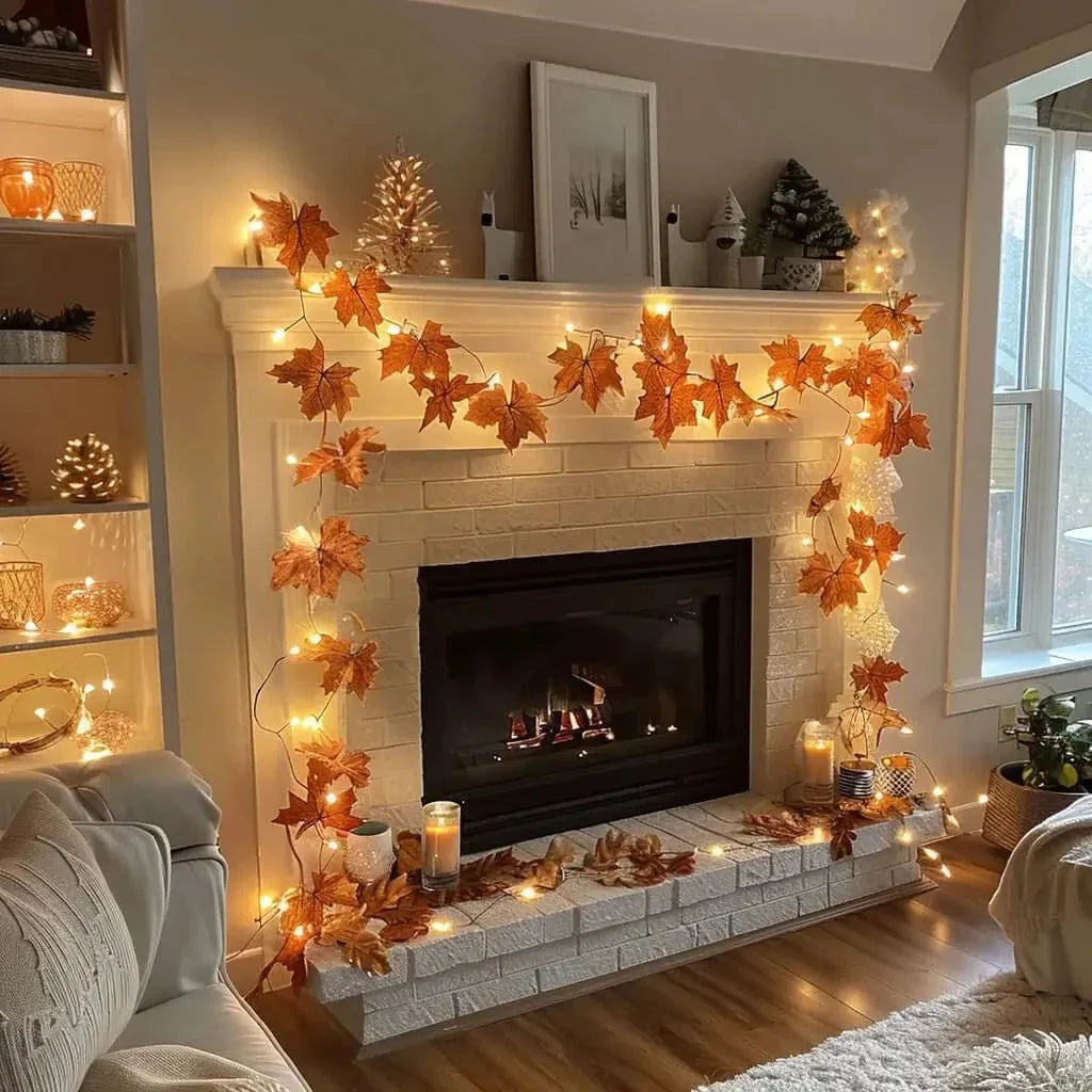 lighted leaf garland draped around fireplace mantel with warm string lights