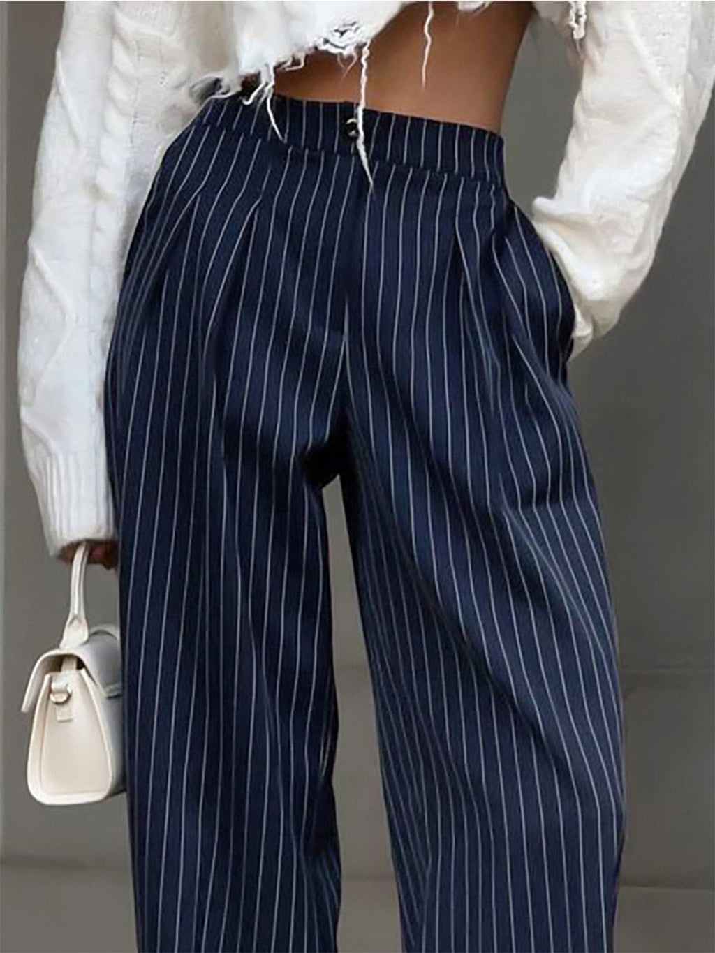 Blue striped high-waisted trousers with elastic waist and vertical stripe pattern