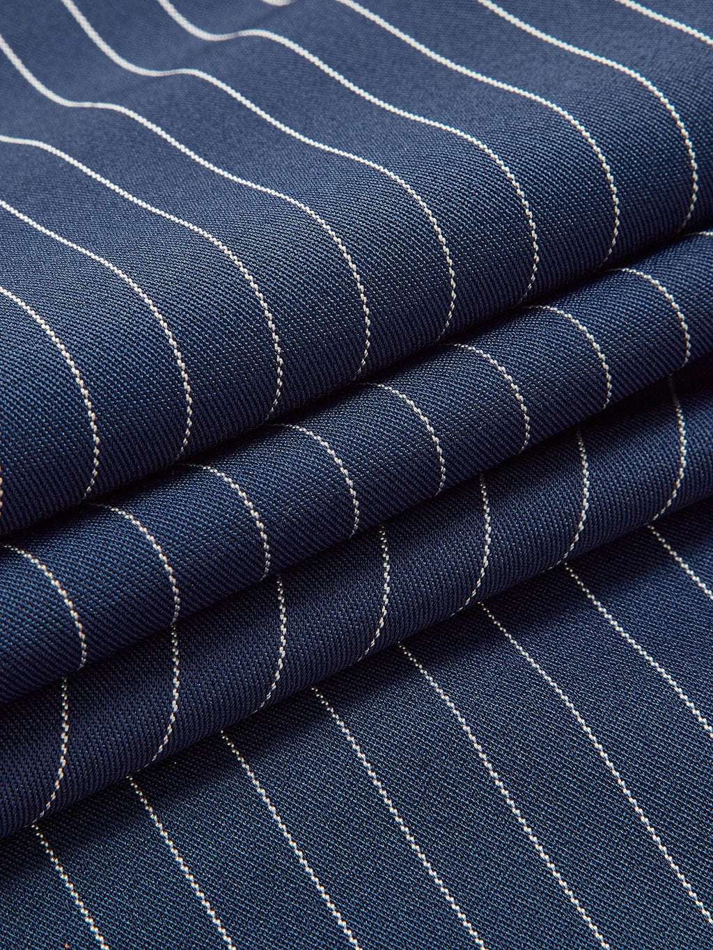 Navy-blue fabric with thin white vertical pinstripes texture close-up