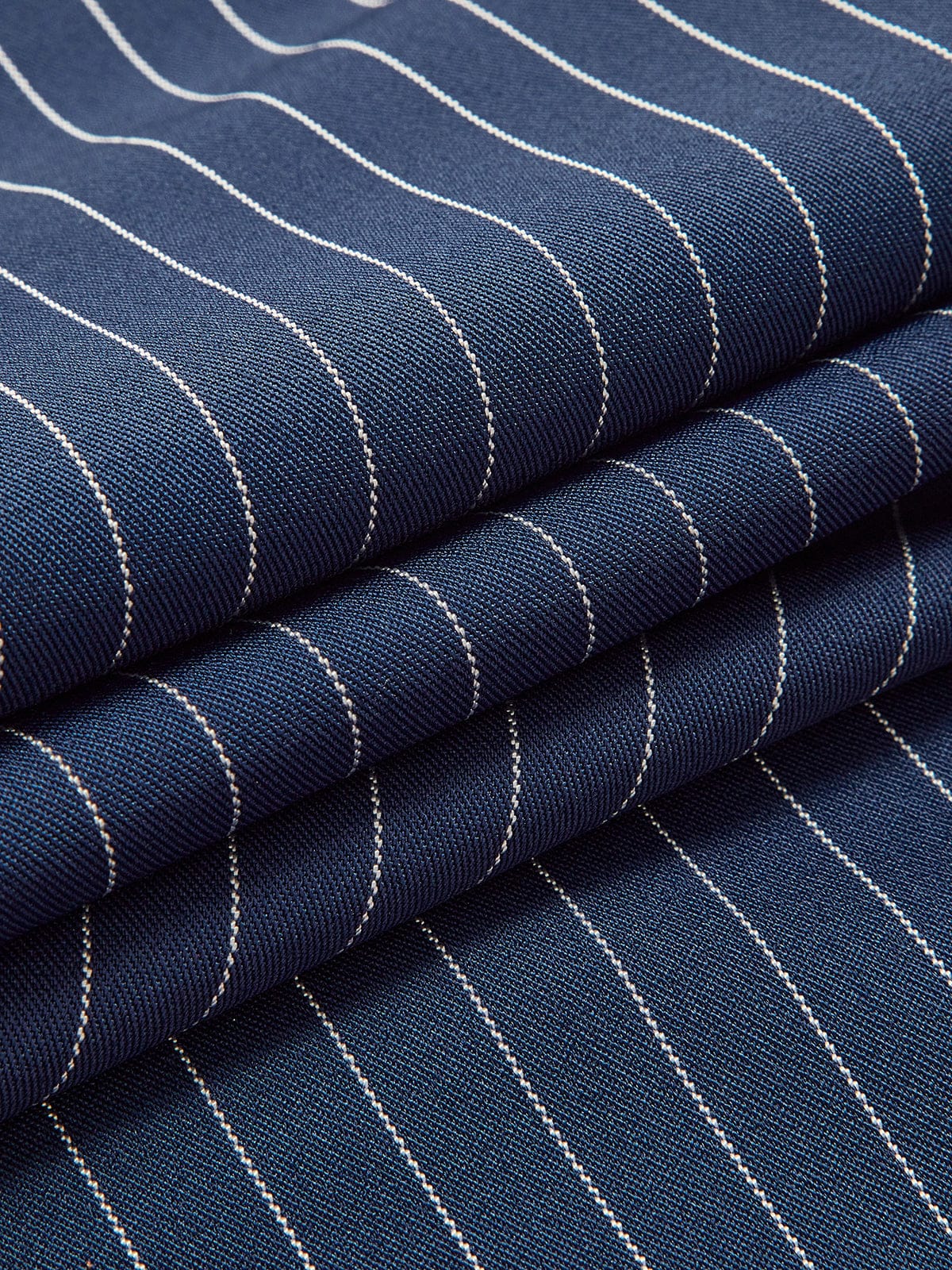 Navy-blue fabric with thin white vertical pinstripes texture close-up
