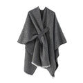 Gray cashmere poncho with V-neck, draped sleeves and tied waist, fringe hem