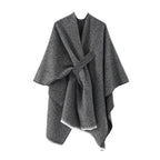 Gray cashmere poncho with V-neck, draped sleeves and tied waist, fringe hem