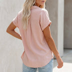 Pink button-up blouse with collar and short sleeves, back view
