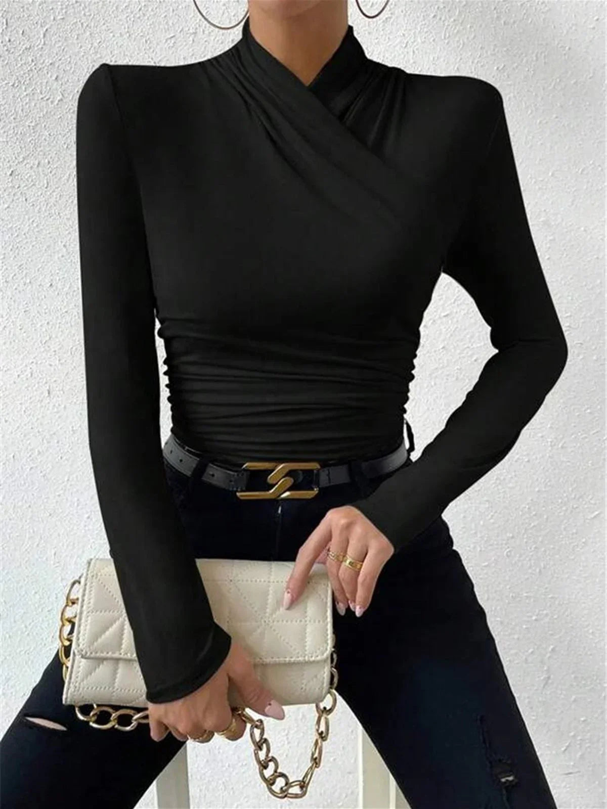 Black wrap turtleneck top with long sleeves and draped wrap front