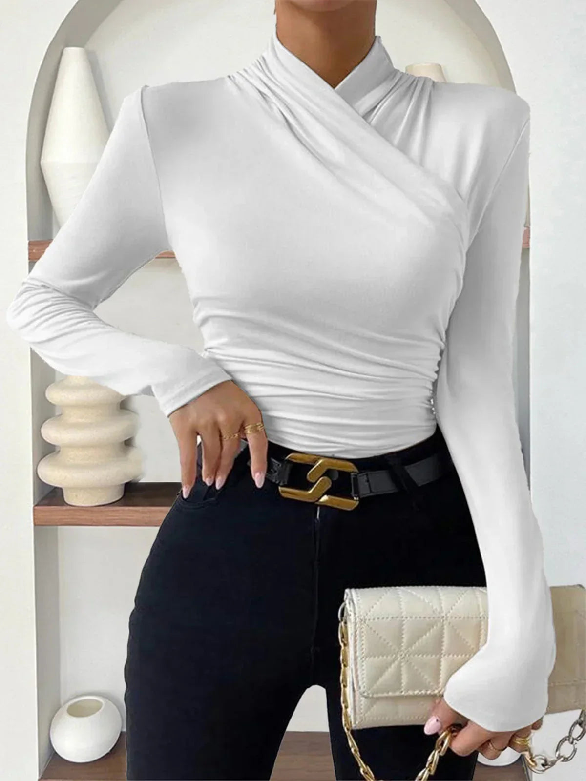 White wrap turtleneck top with long sleeves and ruched waist detail