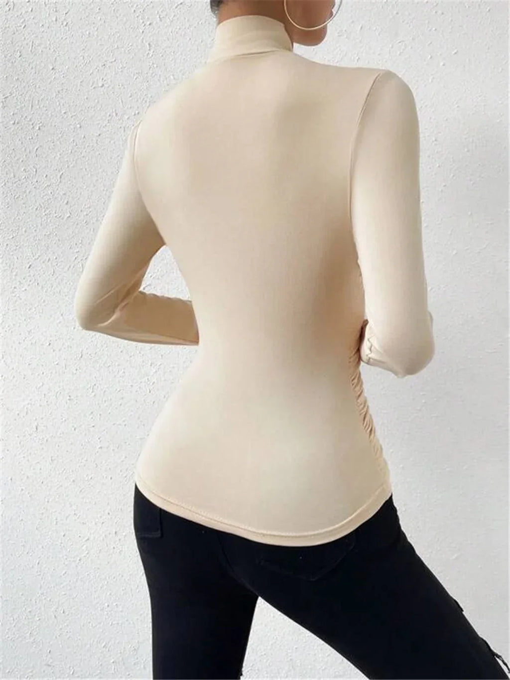 Cream wrap turtleneck top with long sleeves, fitted drape front