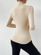 Cream wrap turtleneck top with long sleeves, fitted drape front