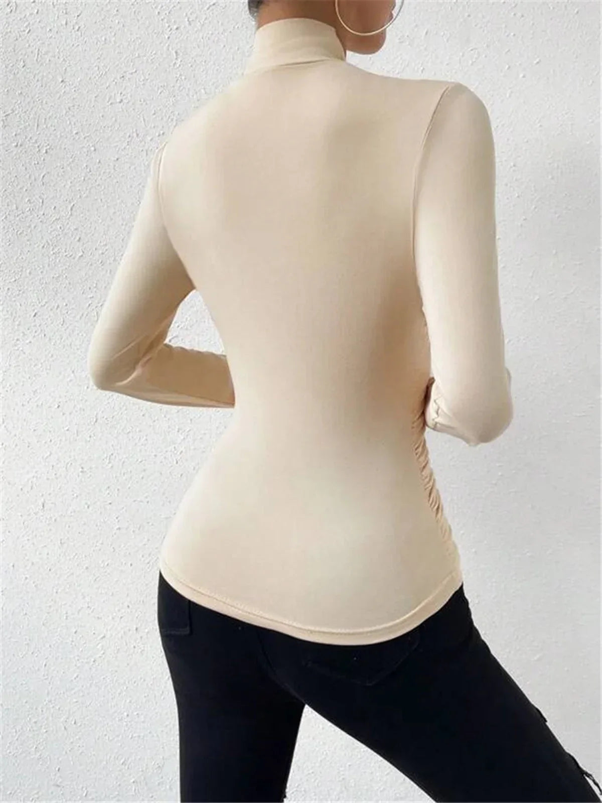 Cream wrap turtleneck top with long sleeves, fitted drape front