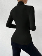 Black wrap turtleneck top with long sleeves and high collar, back view