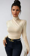 Cream wrap turtleneck top with long sleeves and ruched wrap detail