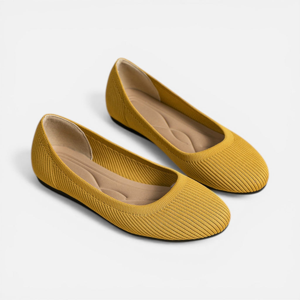 Pair of yellow knit ballet flats with rounded toe and slip-on fit