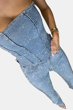 Denim blue strapless glitter jumpsuit close-up: stitched corset bodice and utility pockets