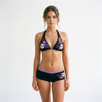Purple floral triangle bikini set with halter neck and matching black swim shorts